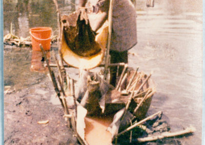 Berik woman washing sago shavings
