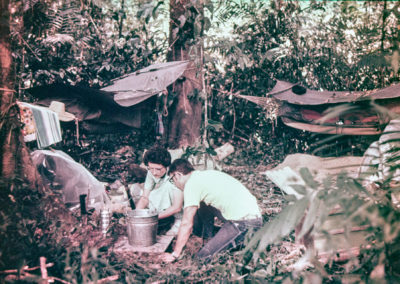 Campers take a break after hanging their jungle hammocks