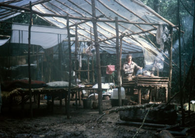 Sue, cooking on a mud stove, in our advance base hut